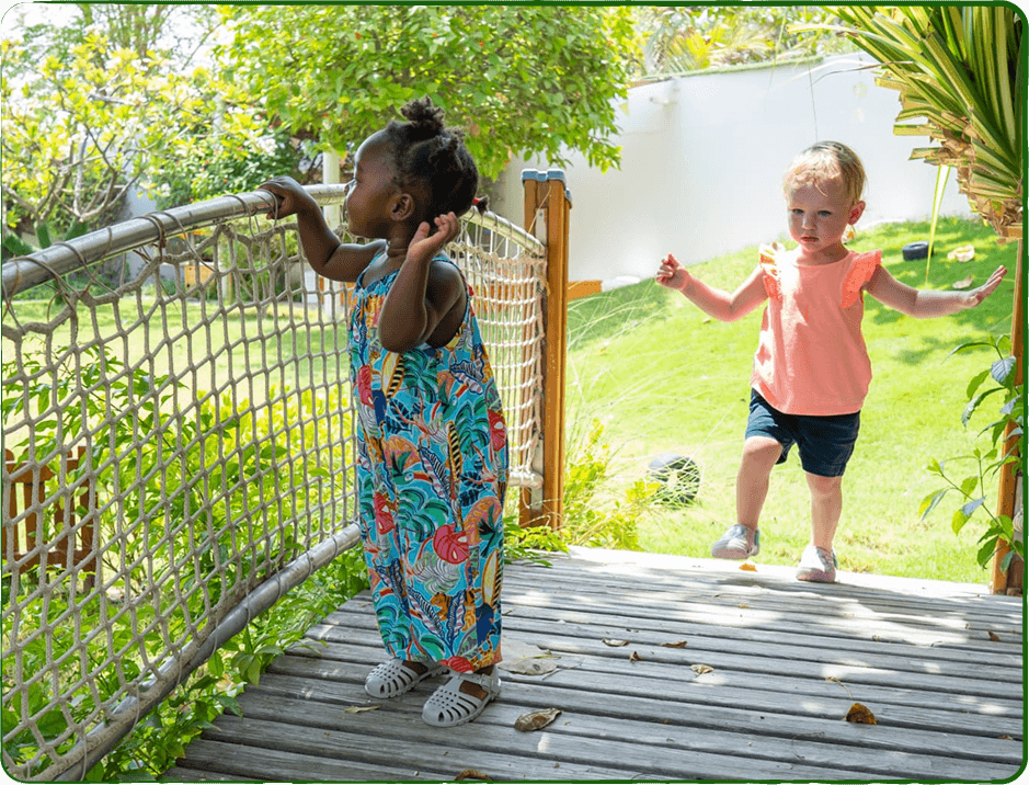Children playing on wooden bridge outdoors